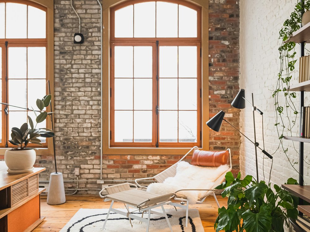 Exposed brick living room with arched industrial windows, Candy Factory Lofts, Queen West