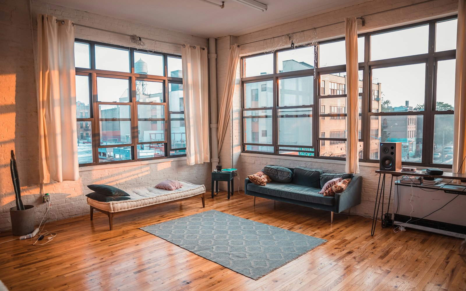 Bright hard loft living space with exposed brick walls and floor-to-ceiling industrial windows, Toronto